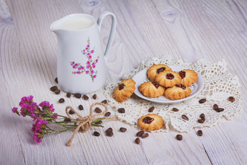 Fototapeta na wymiar Jug with milk and cookie
