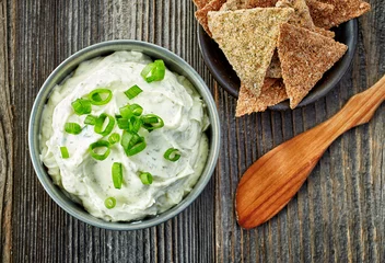 Foto op Canvas cream cheese with green onions and herbs © Mara Zemgaliete
