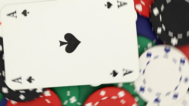 Casino chips with pocket aces rotating - seamless loop