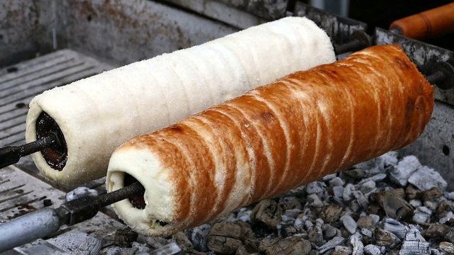Hungarian Kurtoskalacs prepared on the grill, at a traditional food fair. Specific for Transylvania, Romania.