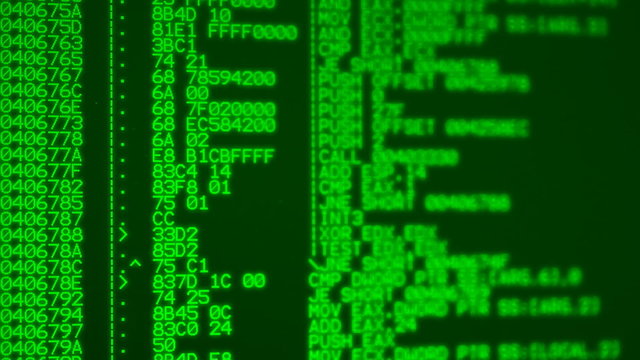 Green glowing computer program assembler source code listing on computer screen - loopable