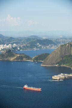 Freight tanker ship travels across Guanabara Bay against the scenic landscape of Rio de Janeiro, Brazil