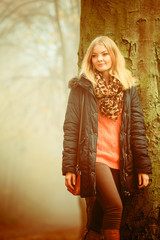 Naklejka premium Woman walking in park in foggy day