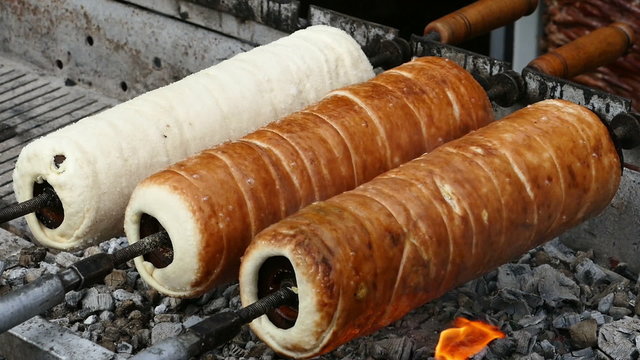 Hungarian Kurtoskalacs prepared on the grill, at a traditional food fair. Specific for Transylvania, Romania.