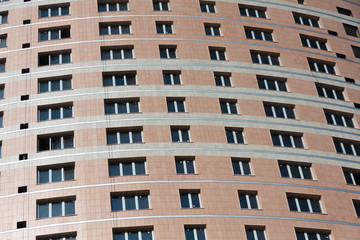 A lot of windows on the brown wall