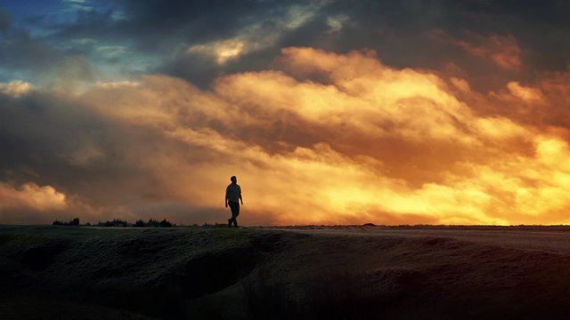 Man Walks On Horizon With Epic Cloudscape