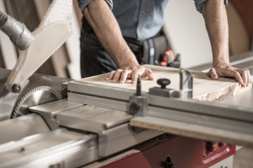 Carpenter using sawing machine