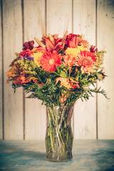 Autumn flower bouquet in vase with vintage tone filter effect