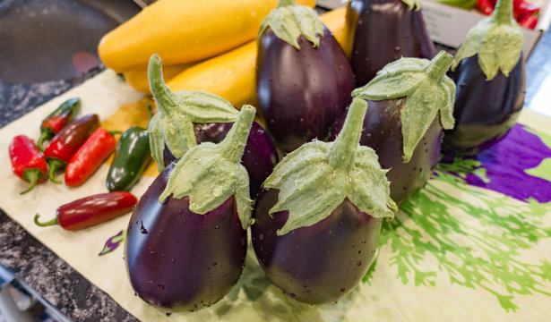 Eggplants and Fresh Vegetables On a Kitchen Counter