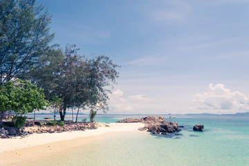 blue sky with sea and beach - soft focus with film filter