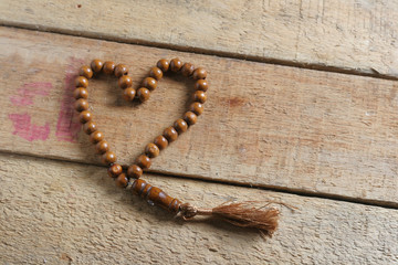 tasbih (moslem prayer beads) at wooden board