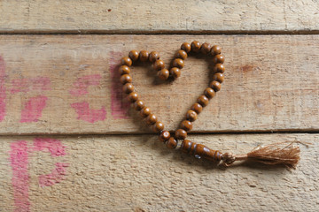 tasbih (moslem prayer beads) at wooden board