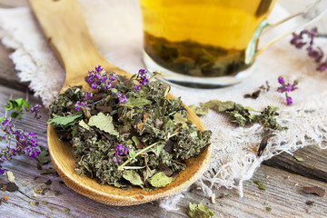Wooden spoon with dry herbal tea.