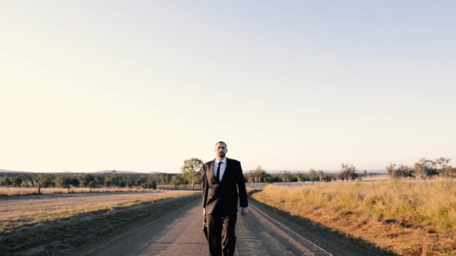 Concept: A frustrated business man is leaving the corporate lifestyle and chasing freedom in the outback of Queensland, Australia. Cinematic Portrait Style.