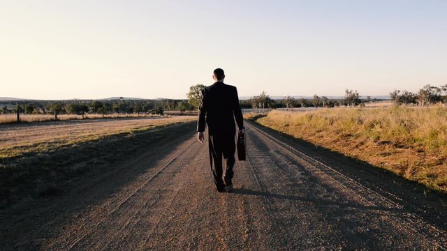 Concept: A frustrated business man is leaving the corporate lifestyle and chasing freedom in the outback of Queensland, Australia. Cinematic Portrait Style.