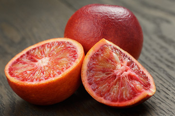 red sicilian oranges sliced on wood table
