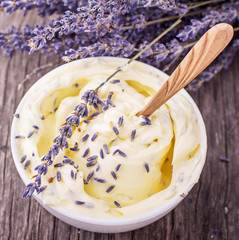 Herbal butter for breakfast with lavender flowers in a white ceramic cup