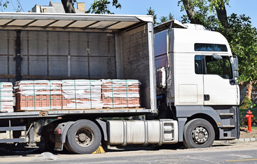 Truck delivers paving stones to the road construction