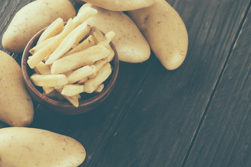french fries on wood background - soft focus with vintage film f