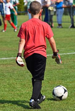 Goalkeeper with a ball at the kid's soccer match