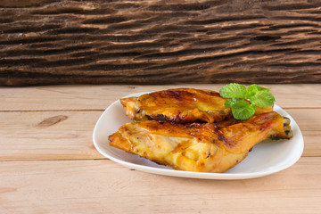 grilled chicken  on white dish,wood background