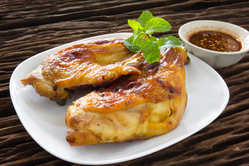 grilled chicken  on white dish,wood background