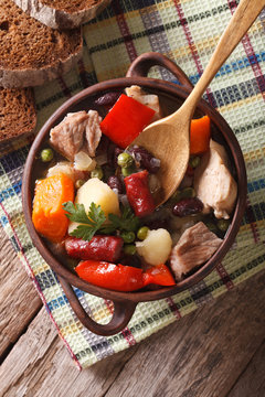 German eintopf soup with meat and vegetables close-up vertical top view 
