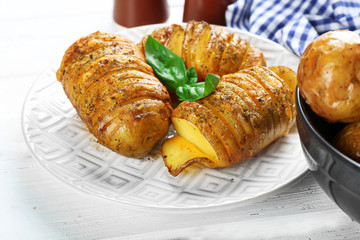 Baked potatoes on wooden table, closeup