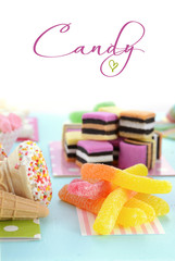 Obraz na płótnie Canvas Bright Colorful Candy on Pale Bluw Wood Table.