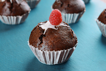 Delicious chocolate cupcakes with berries on table close up