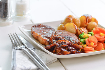 Pork chop Sunday lunch with onion gravy.
