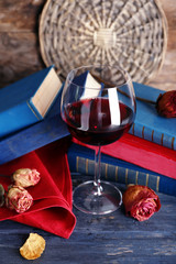 Naklejka na ściany i meble Beautiful composition with glass of wine with old books on table close up