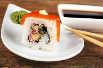 Roll with sauce and sticks on wooden table close up