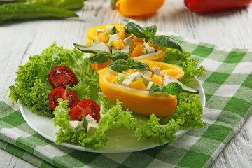 Fresh green salad in pepper on table close up