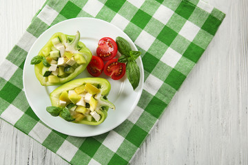 Fresh green salad in pepper on table close up