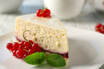 Delicious cheesecake with berries on table close up