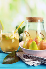 Fresh pear juice with fruit on bright background