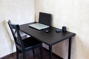 desk with a laptop and a chair in office