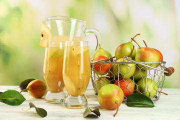 Fresh pear juice with fruit on bright background