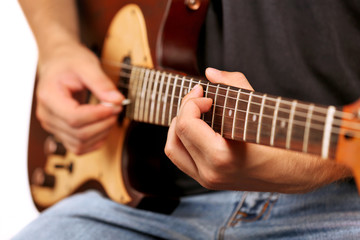 Fototapeta na wymiar Young musician playing electric guitar close up