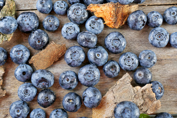Tasty ripe blueberries on wooden table close up