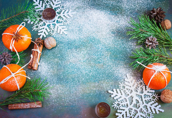 Winter Christmas decorations - tangerines, walnuts, snowflakes, cinnamon and candles. with space for text