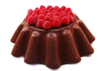 Tasty chocolate muffin with raspberries isolated on white