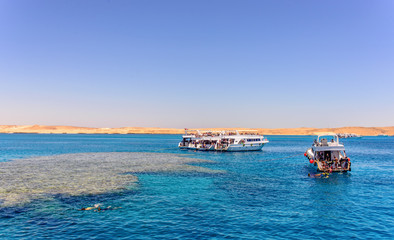 Group of tour ships and dive boats