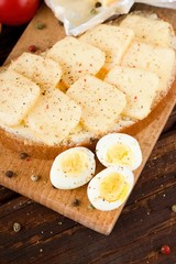 Top view on chopping board with quail eggs and bread