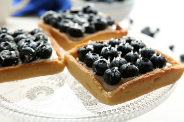 Gourmet fresh blueberry tarts on plate, close up