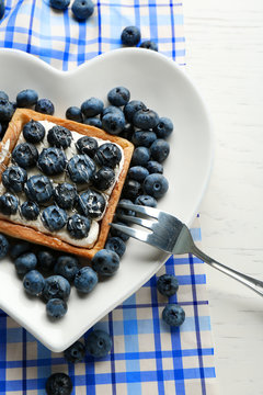 Gourmet fresh blueberry tart on plate, close up