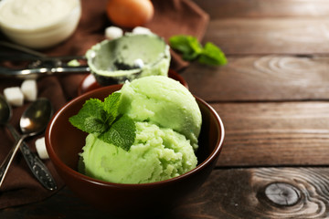Homemade mint ice-cream on dark wooden background