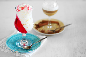 Tasty Jelly desserts with cream on light background