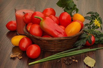 tomatoes and fresh herbs in a basket on the table